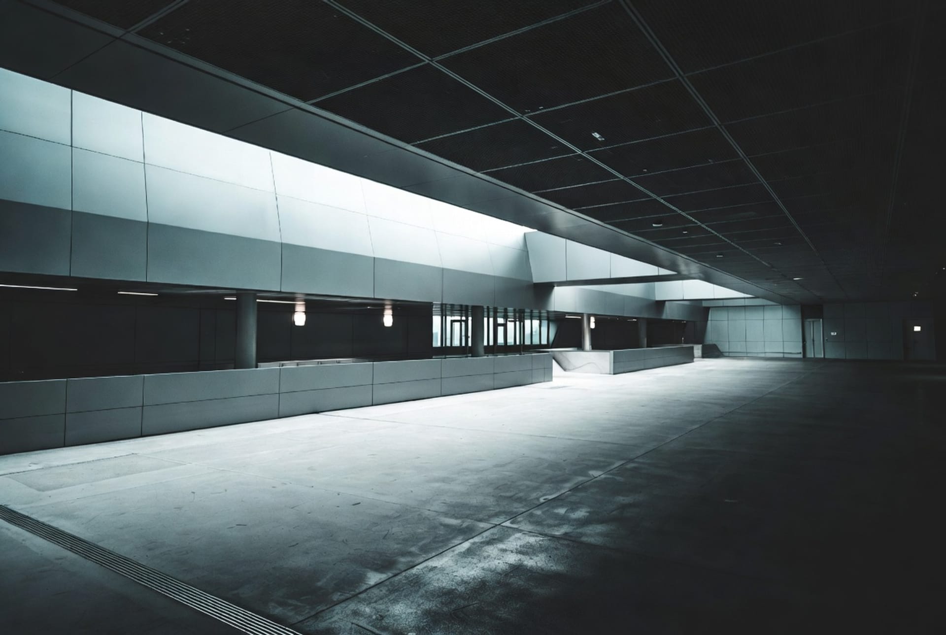 An empty, modern building interior in low light