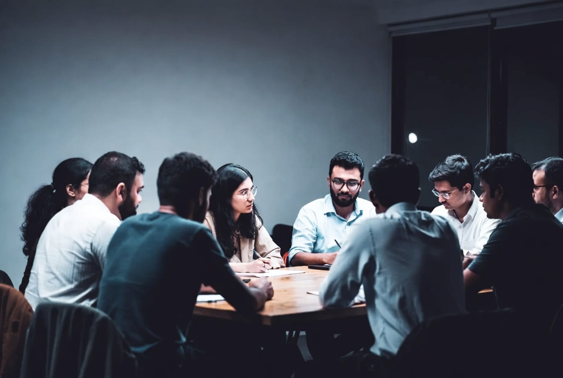 A project team working through ideas around a meeting table