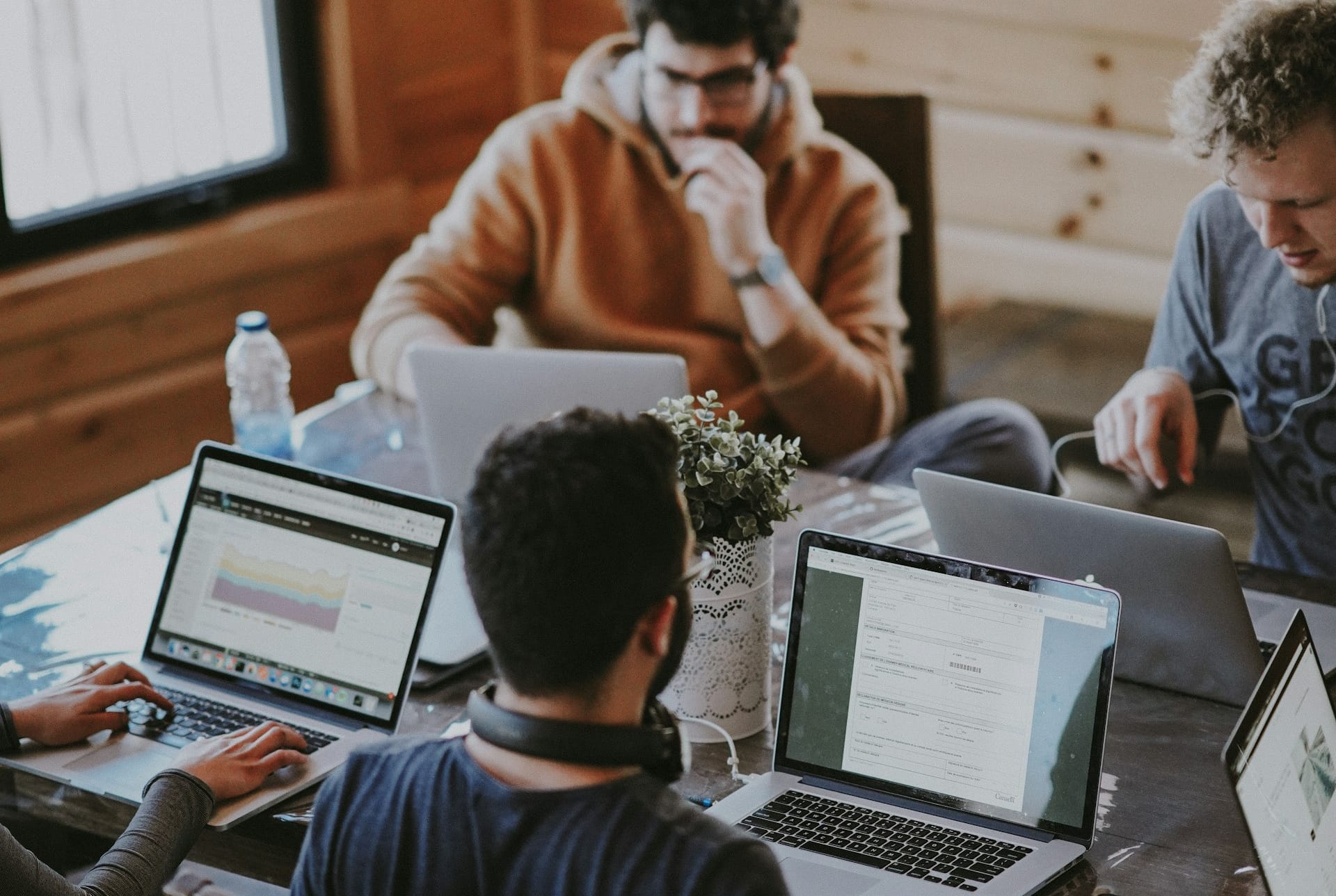 A team working together on laptops around a table